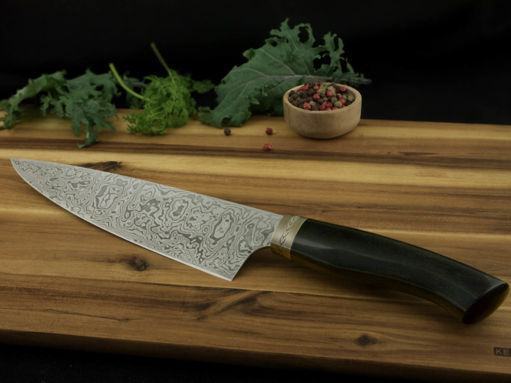 K022-3 Professional chef's knife made of Damascus steel. Ebony handle with hand-engraved nickel silver bolster.